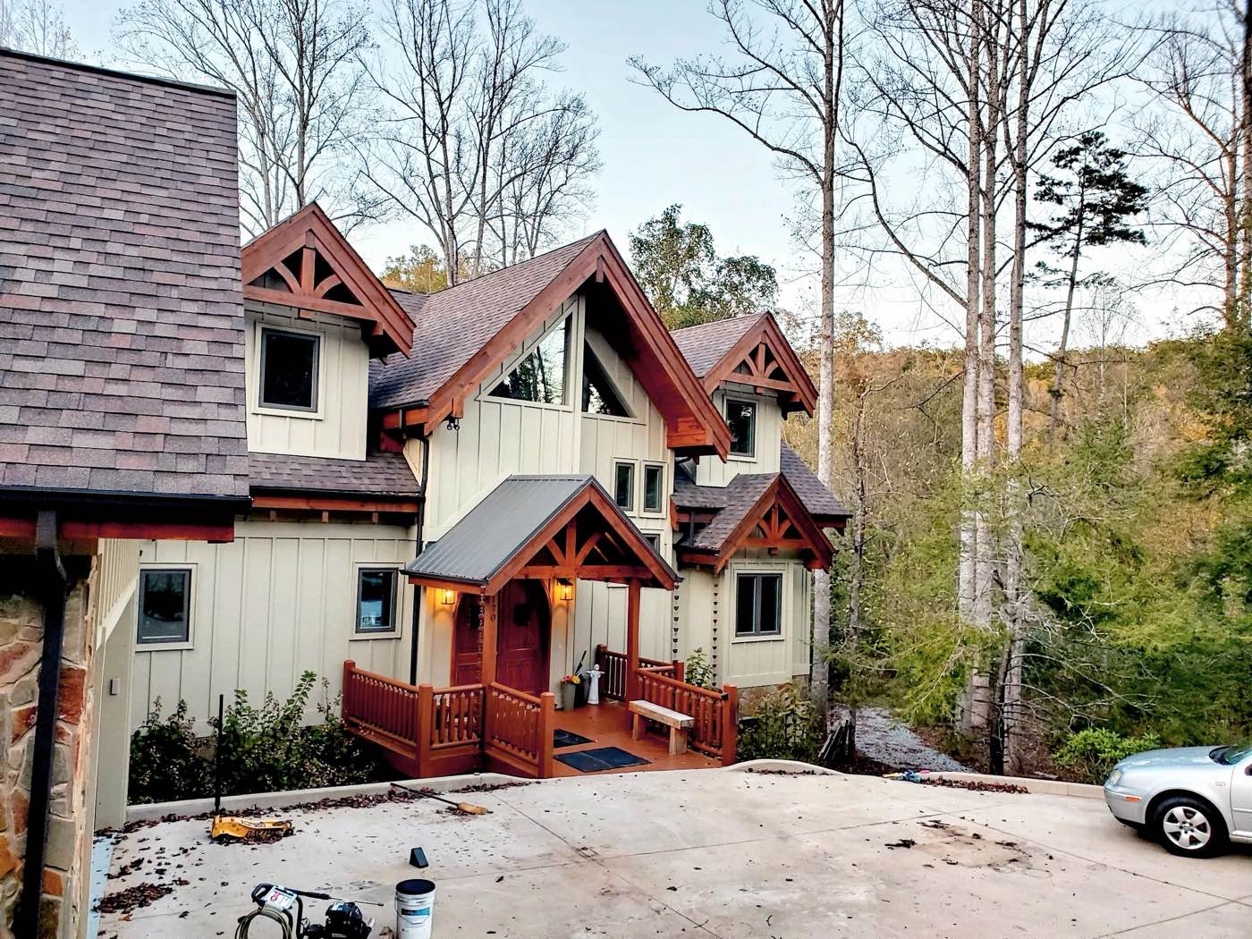 Craftsman-style home with cream board-and-batten siding and cedar-stained gables, trim and porch