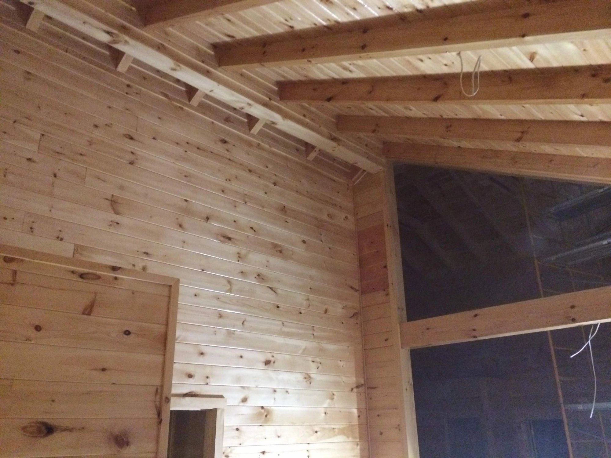 Interior with pine tongue-and-groove walls and ceiling beams