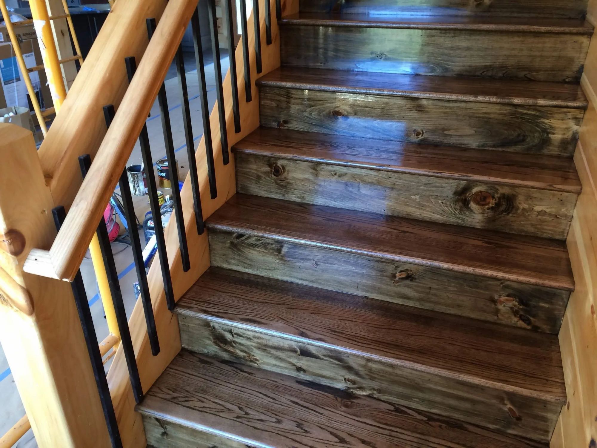 Staircase with glossy stained pine treads and black balusters